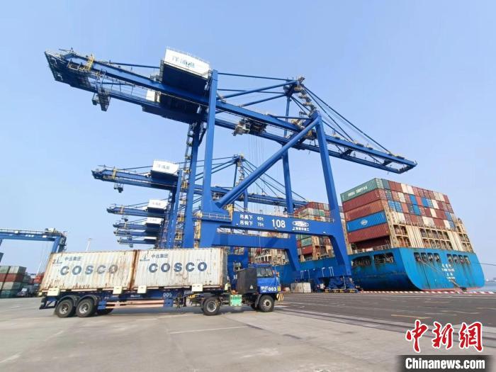 圖為海南洋浦國際集裝箱碼頭，卡車將集裝箱從后方堆場運往碼頭裝卸區(qū)?！堅潞?攝