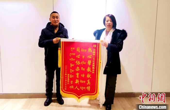 圖為聶榮縣完全小學(xué)向西藏高山文化發(fā)展基金會贈送錦旗?！∮谫e 攝